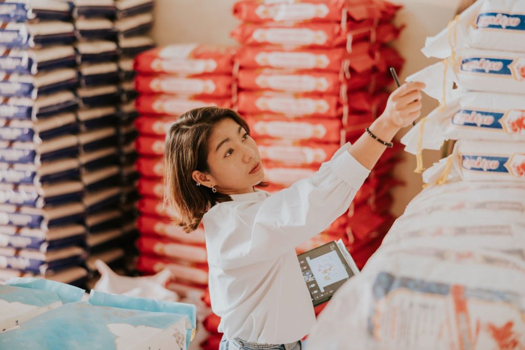 Wholesale Thai rice owner at her rice shop for working everyday